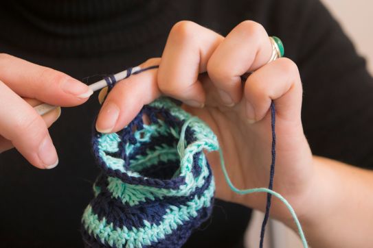 cropped-image-of-woman-knitting-booties-at-home-592265923-583c7e755f9b58d5b16df001